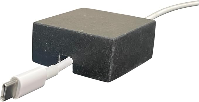 Cord Holder – Black Granite Cable Tidy, Single | Handmade honed black granite cord holder keeps a charging cable tidy on your desk. Weighted, non-slip. Single slot.